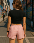 Woman standing on city street wearing RF-Wear Women's Paisley Shorts - Pink/Cream -  Back View
