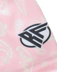 Close-up of a pink/cream paisley fabric with a brand logo