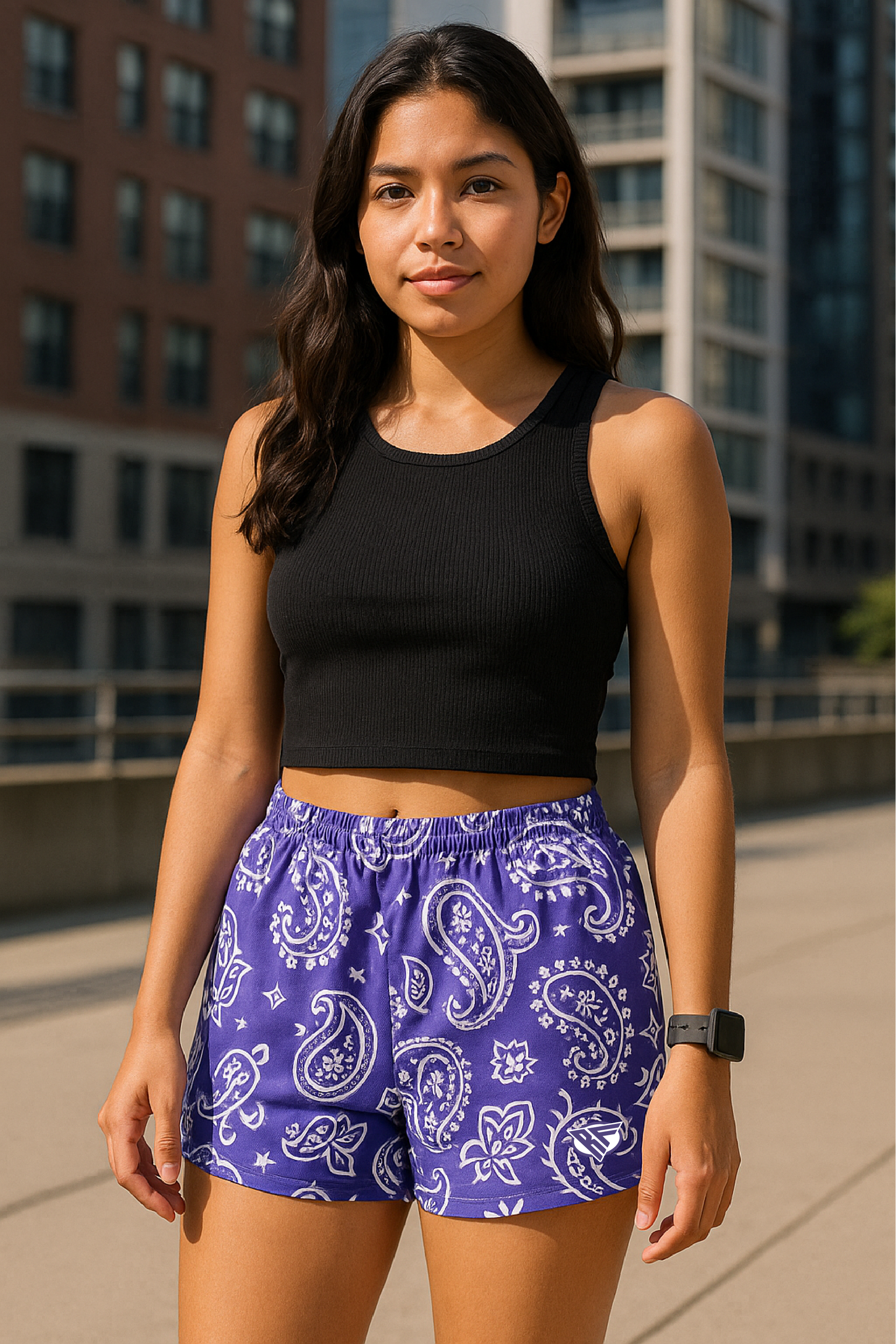 Woman standing on the city street wearing RF-Wear Women's Paisley Shorts - Purple/White - Front View