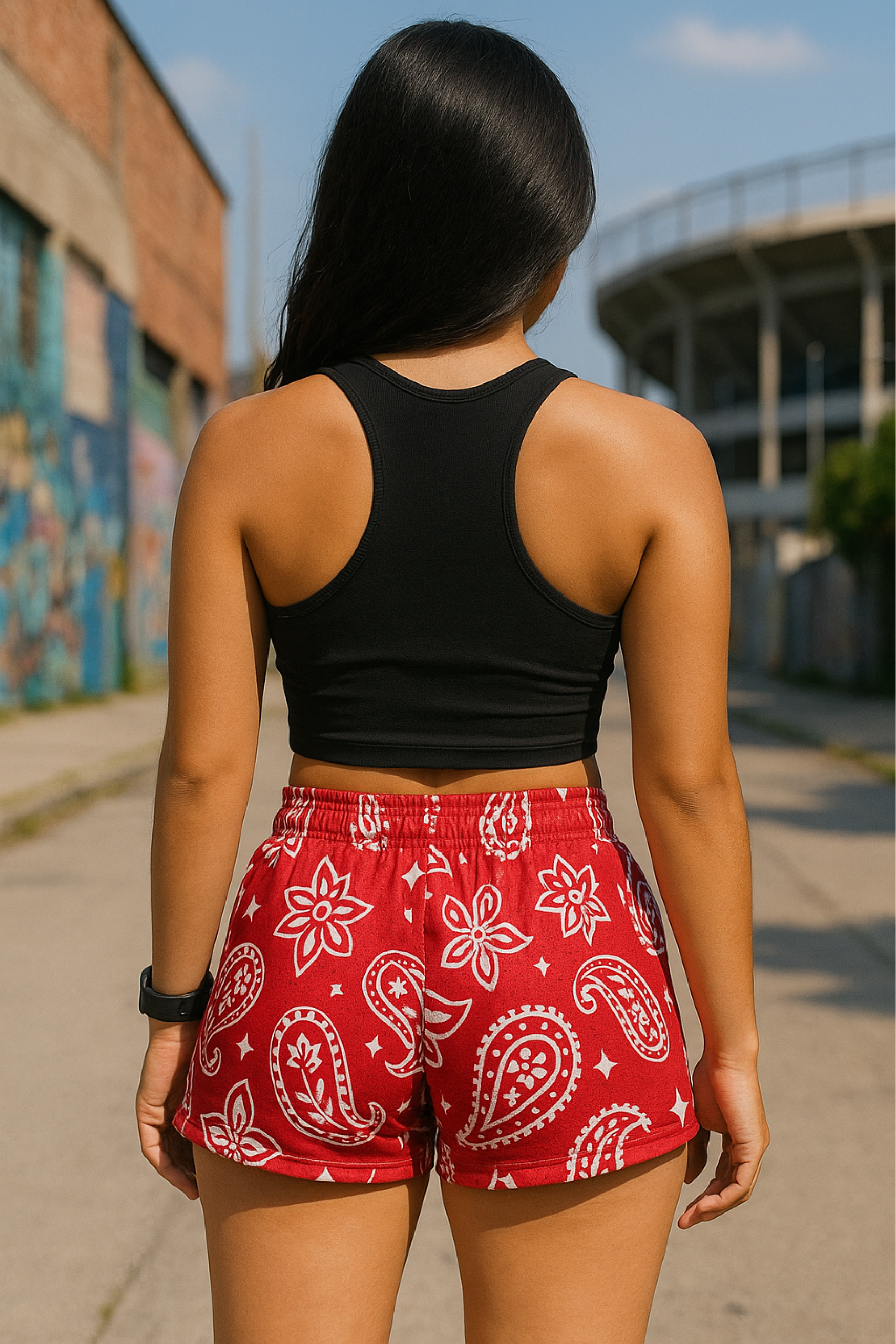 Woman standing near buildings wearing RF-Wear Women's Paisley Shorts - Red/White - Back View