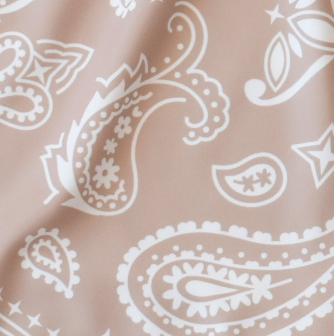 Close-up women's tan/white paisley shorts