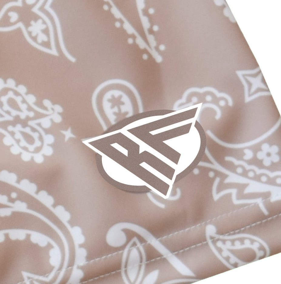 Close-up women's tan/white  paisley shorts with brand logo