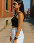 Woman on sidewalk wearing RF-ddWear Women's Paisley Shorts - White/Baby Blue - Model Side View