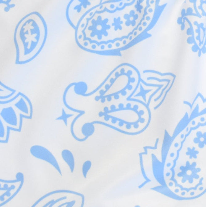 Close-up women's white/baby-blue paisley shorts.