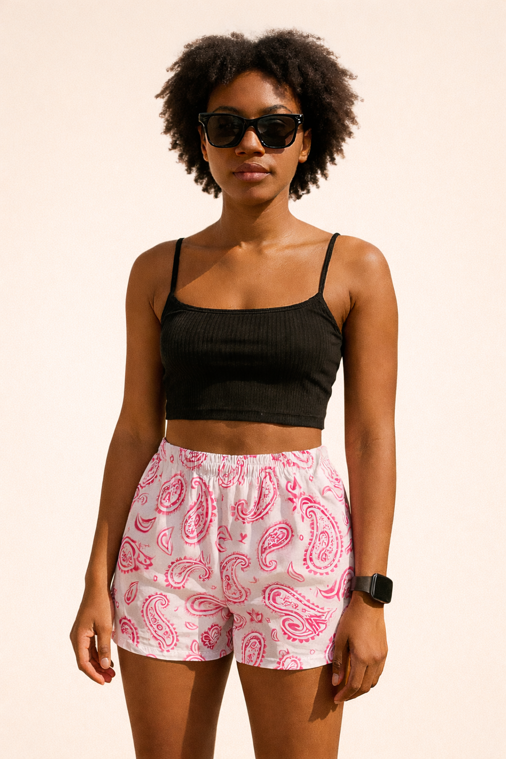 Woman wearing a black top and RF-Wear Women's Paisley Shorts in White/Fuchsia