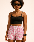 Woman wearing a black top and RF-Wear Women's Paisley Shorts in White/Fuchsia