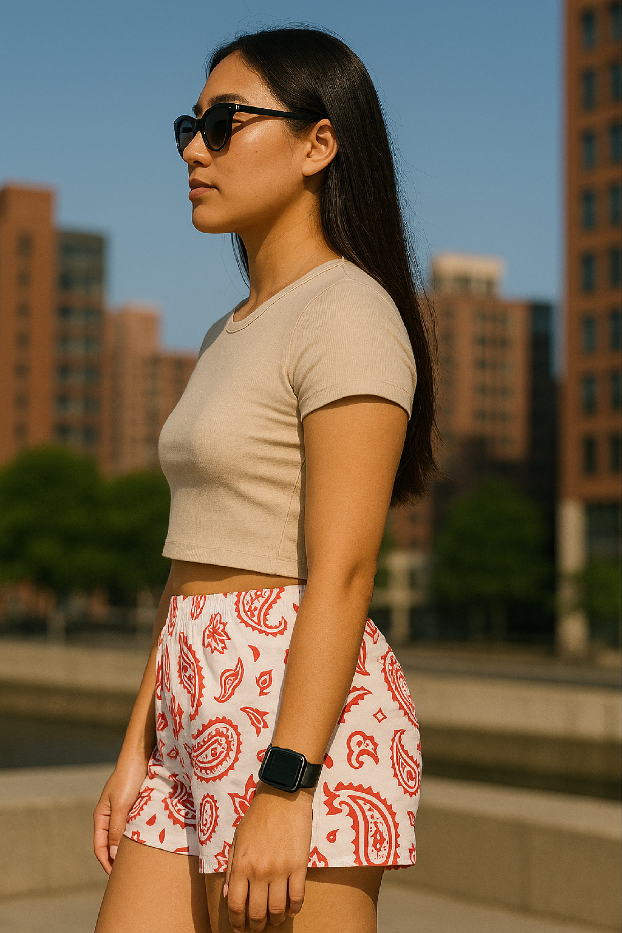 Woman standing in city wearing RF-Wear Women's Paisley Shorts - White/Red - Side View