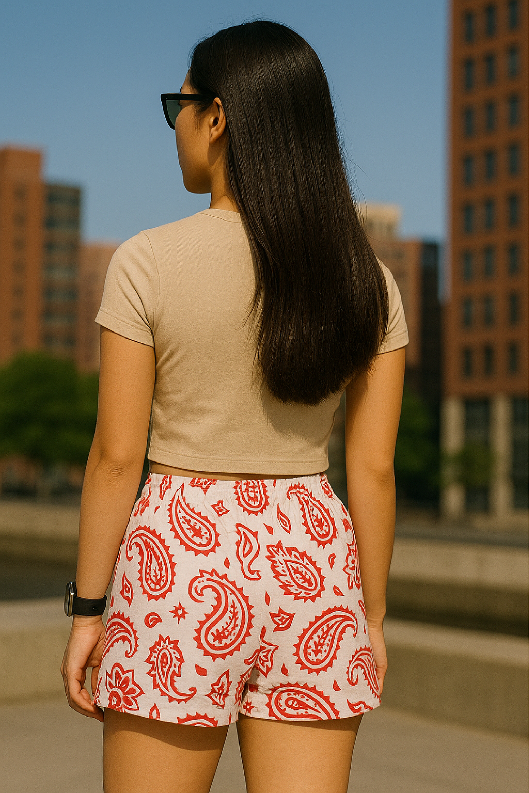 Woman standing in city wearing RF-Wear Women's Paisley Shorts - White/Red - Back View