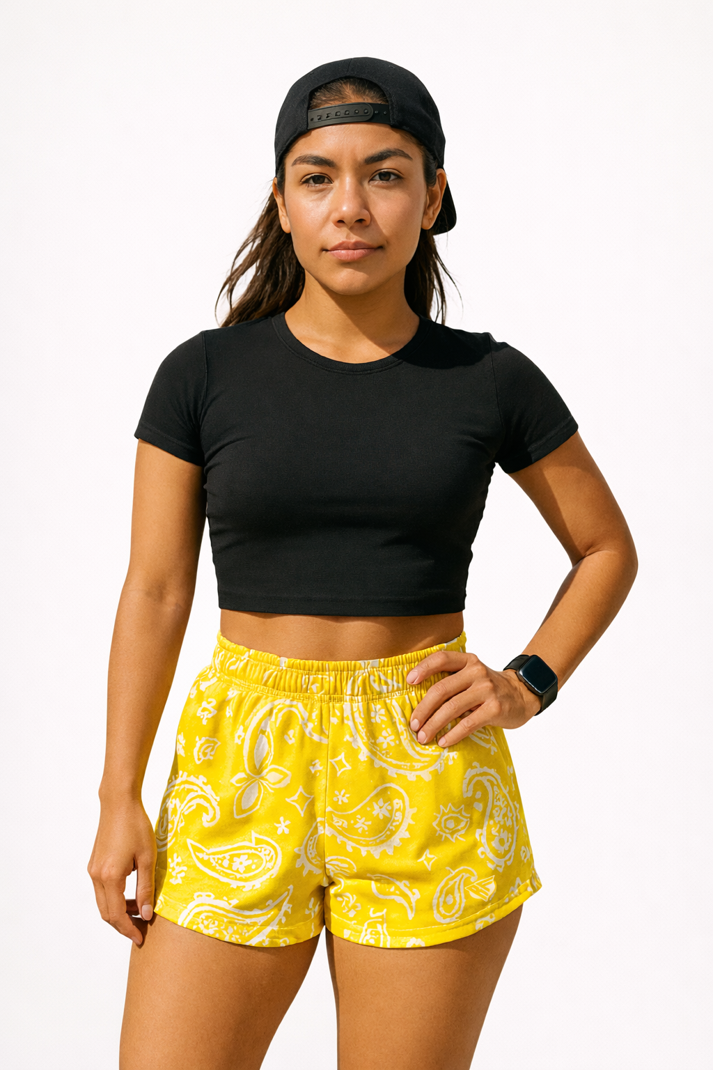 Woman wearing a black top and RF-Wear Women's Paisley Shorts in Yellow/White 
