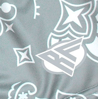 Close-up of RF-Wear Women's Split Paisley Shorts in Green/Silver with RF logo