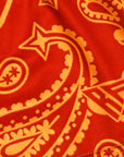 Close-up of RF-Wear Women's Split Paisley Shorts in Red/Gold with RF logo