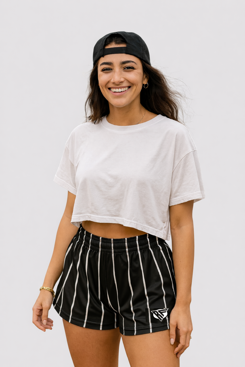 Woman wearing a white short sleeve crop top and RF-Wear Women's Pinstripe Shorts in Black/White 