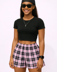 Woman wearing a black top Women's Plaid Shorts in Black/Pink