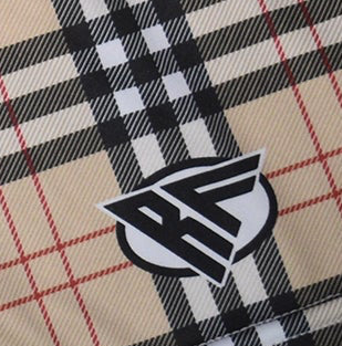 Close-up of RF-Wear Women's Tartan Plaid Shorts in Tan/Black with RF logo