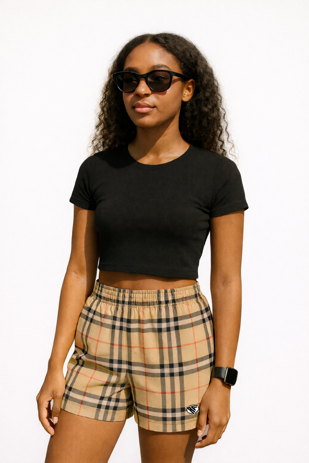 Woman wearing a black top and RF-Wear Women's Tartan Plaid Shorts in Tan/Black