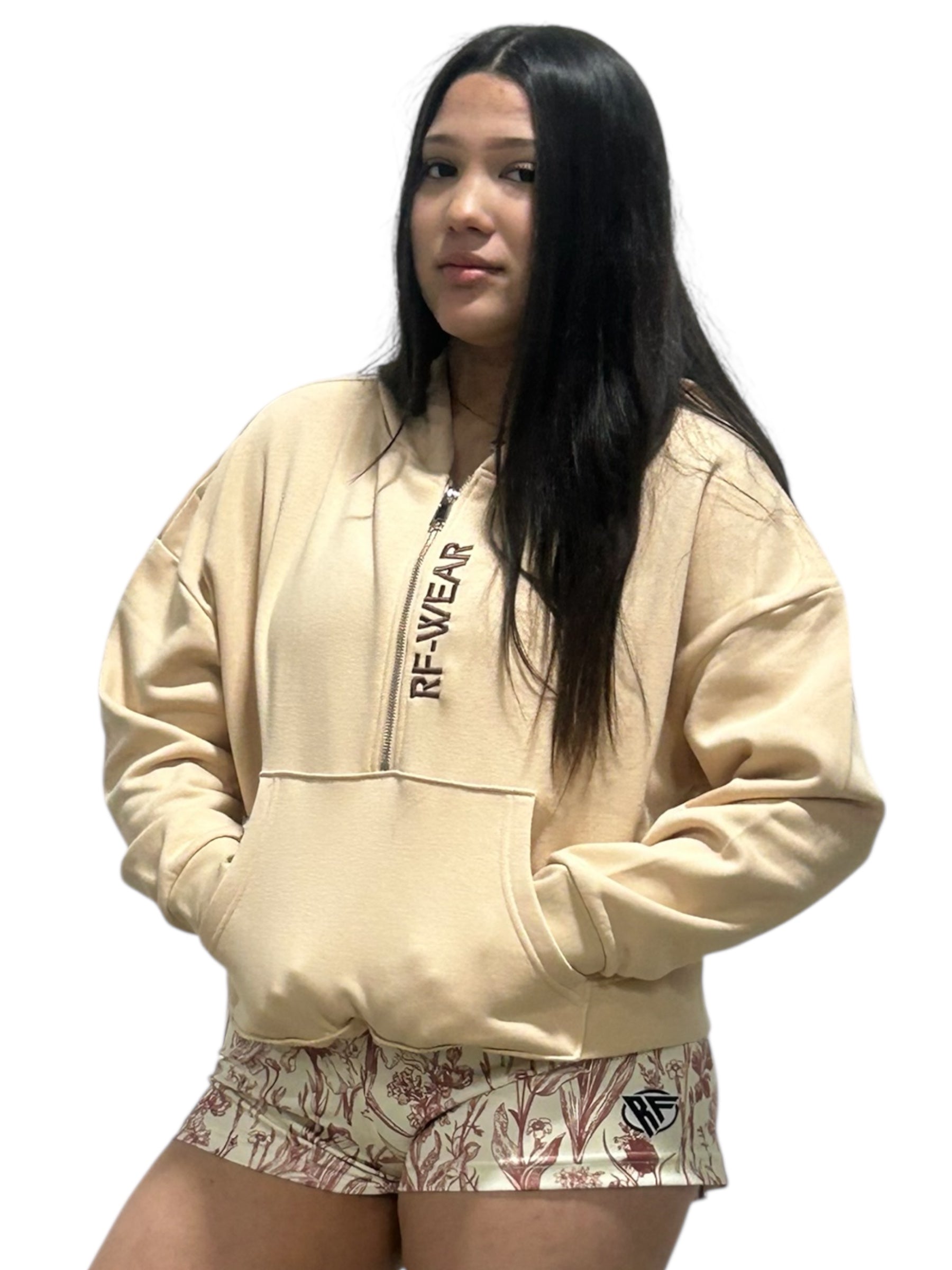 Woman wearing a cream RF-Wear Hoodie with RF-Wear women's porcelain shots in Rose Cream.