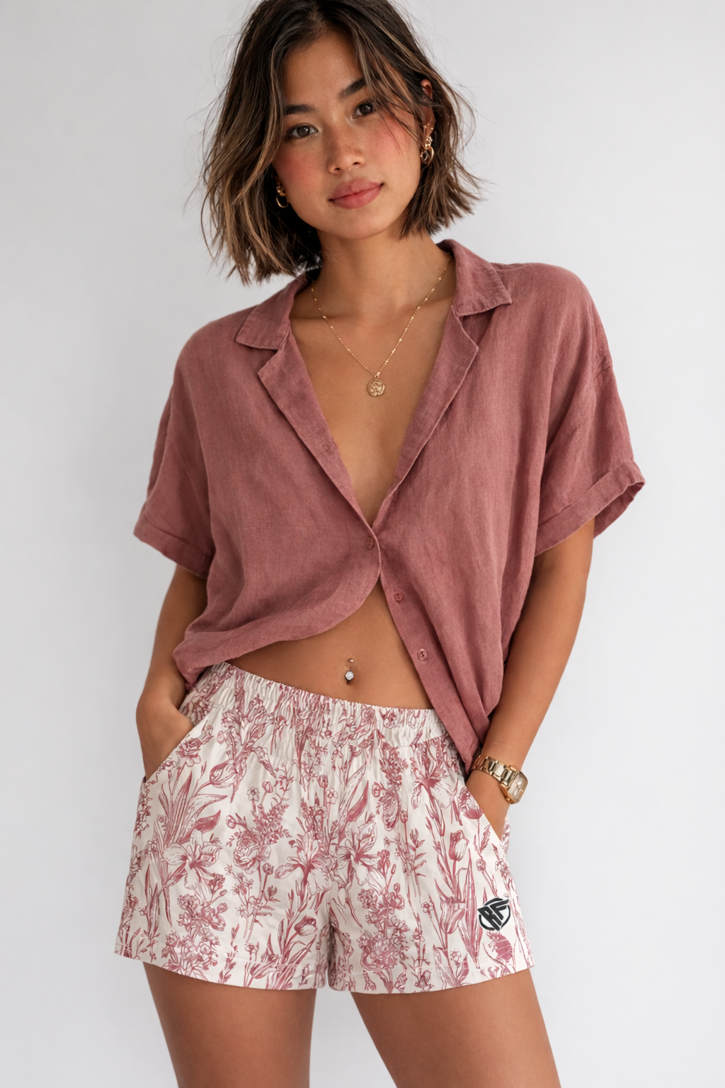 Woman wearing a rose colored top and RF-Wear Women's Porcelain Shorts in Rose/Cream