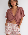 Woman wearing a rose colored top and RF-Wear Women's Porcelain Shorts in Rose/Cream