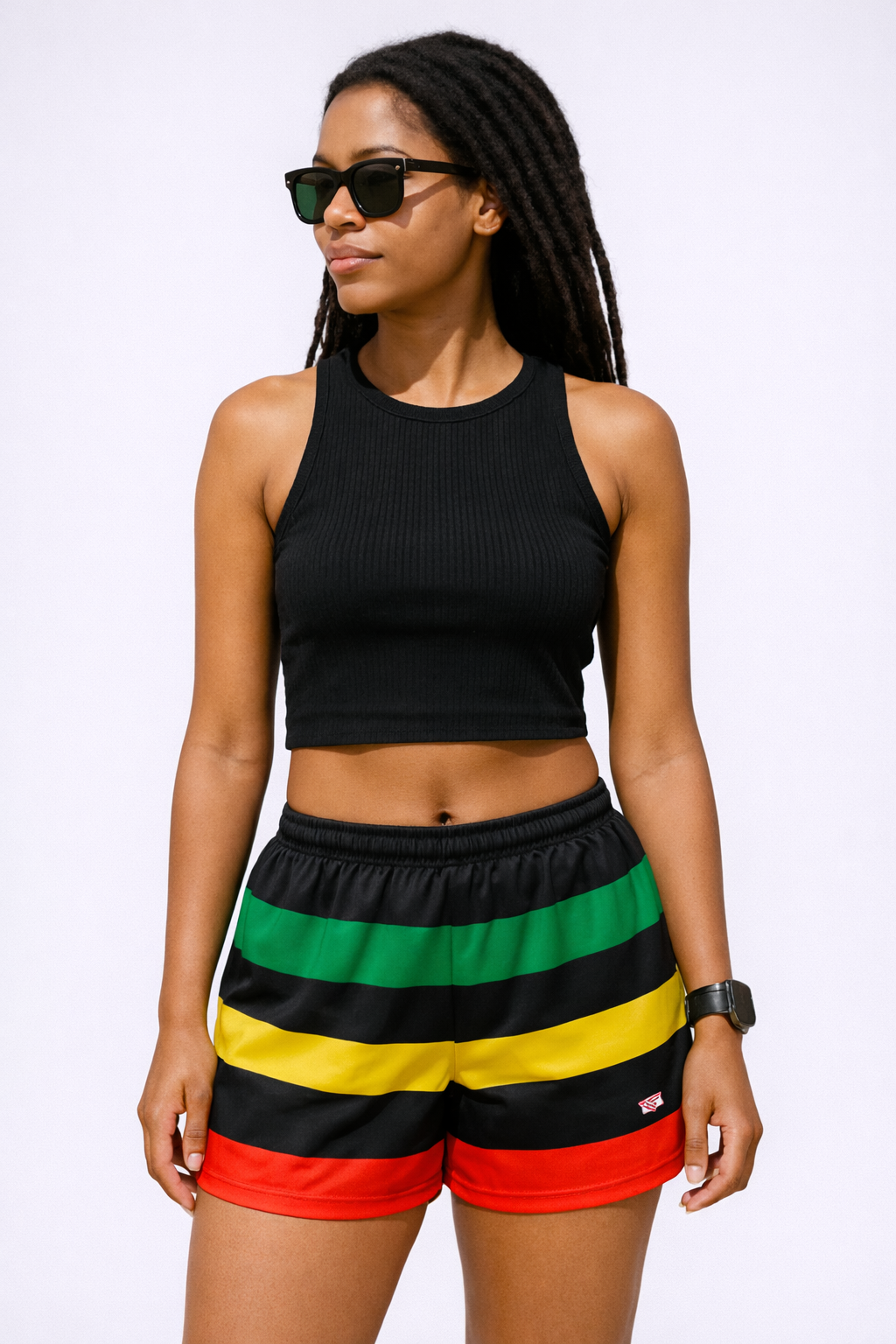 Woman wearing a black top and RF-Wear Women's Rasta Shorts in Multicolors