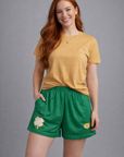Woman wearing a gold t-shirt and RF-Wear Women's Shamrock Shorts in Green