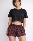 Woman wearing a black top and RF-Wear Women's Skull Shorts 2.0 in Black/Red