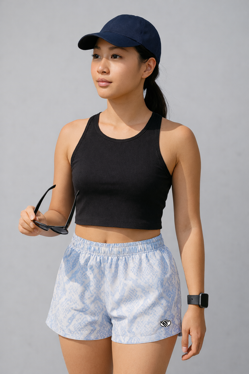 Woman wearing black top and RF-Wear Women's Snakeskin Shorts in Baby Blue 
