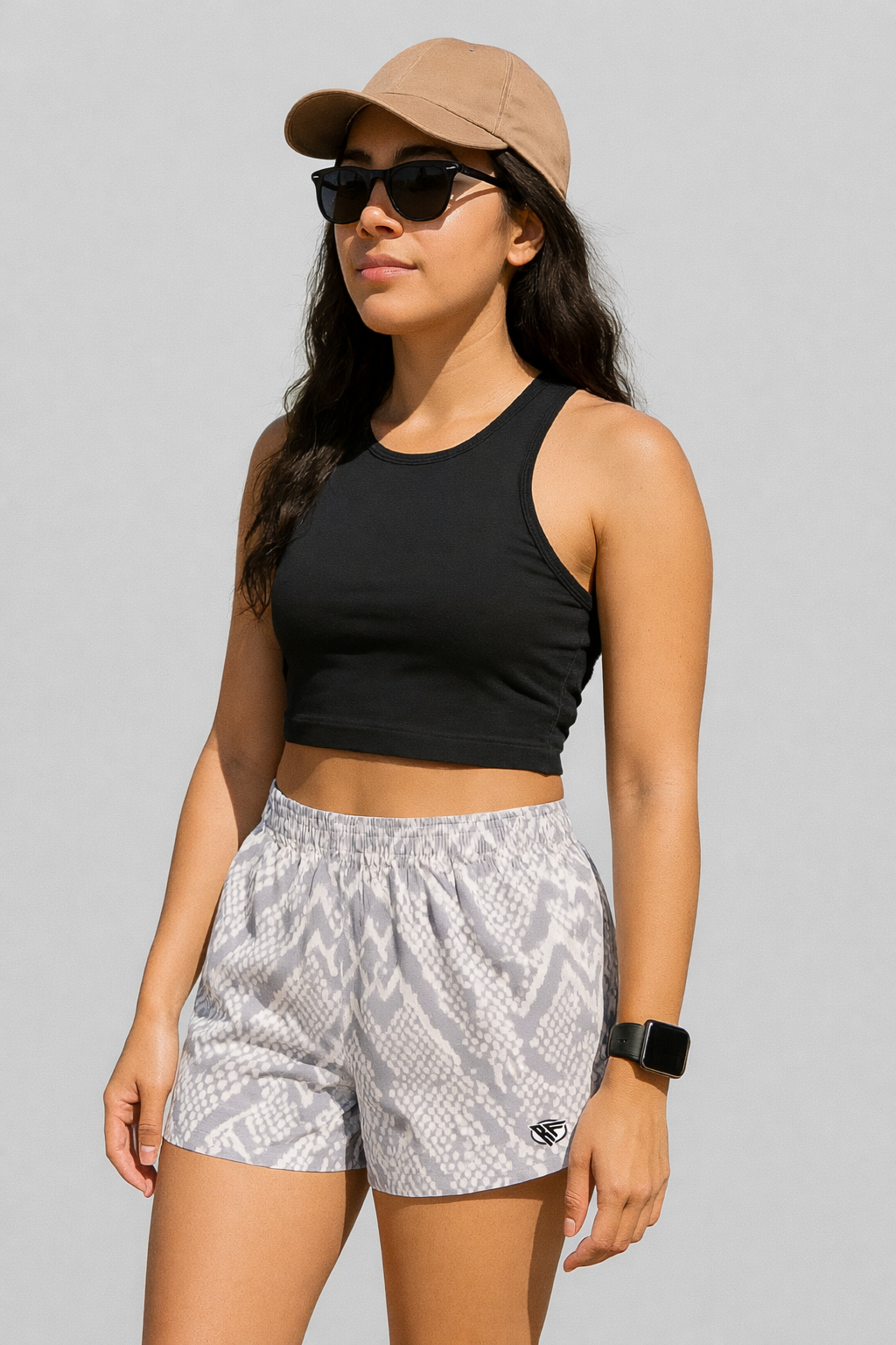 Woman wearing a black top and RF-Wear Women's Snakeskin Shorts in Cream/Grey 