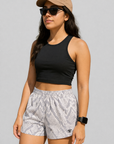 Woman wearing a black top and RF-Wear Women's Snakeskin Shorts in Cream/Grey 