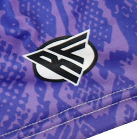 Close-up purple snakeskin shorts with brand logo