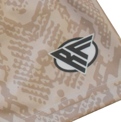 Close-up women's tan snakeskin shorts with brand logo