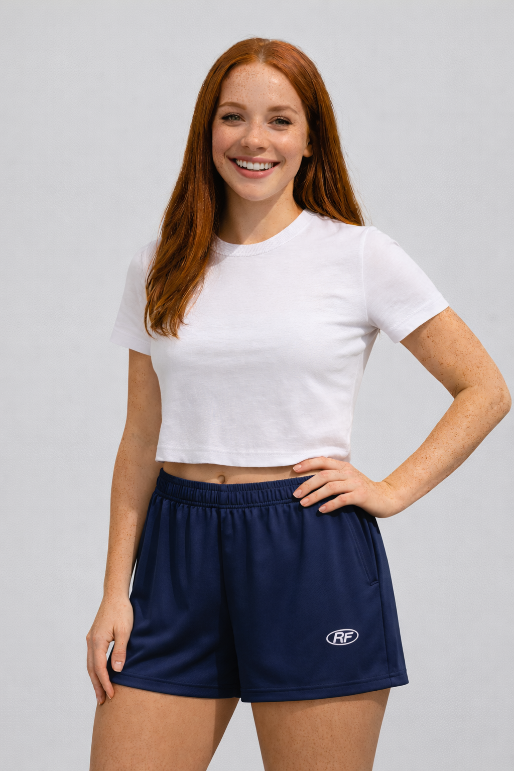 Woman wearing a white top and RF-Wear Women's Solid Color Shorts in Navy
