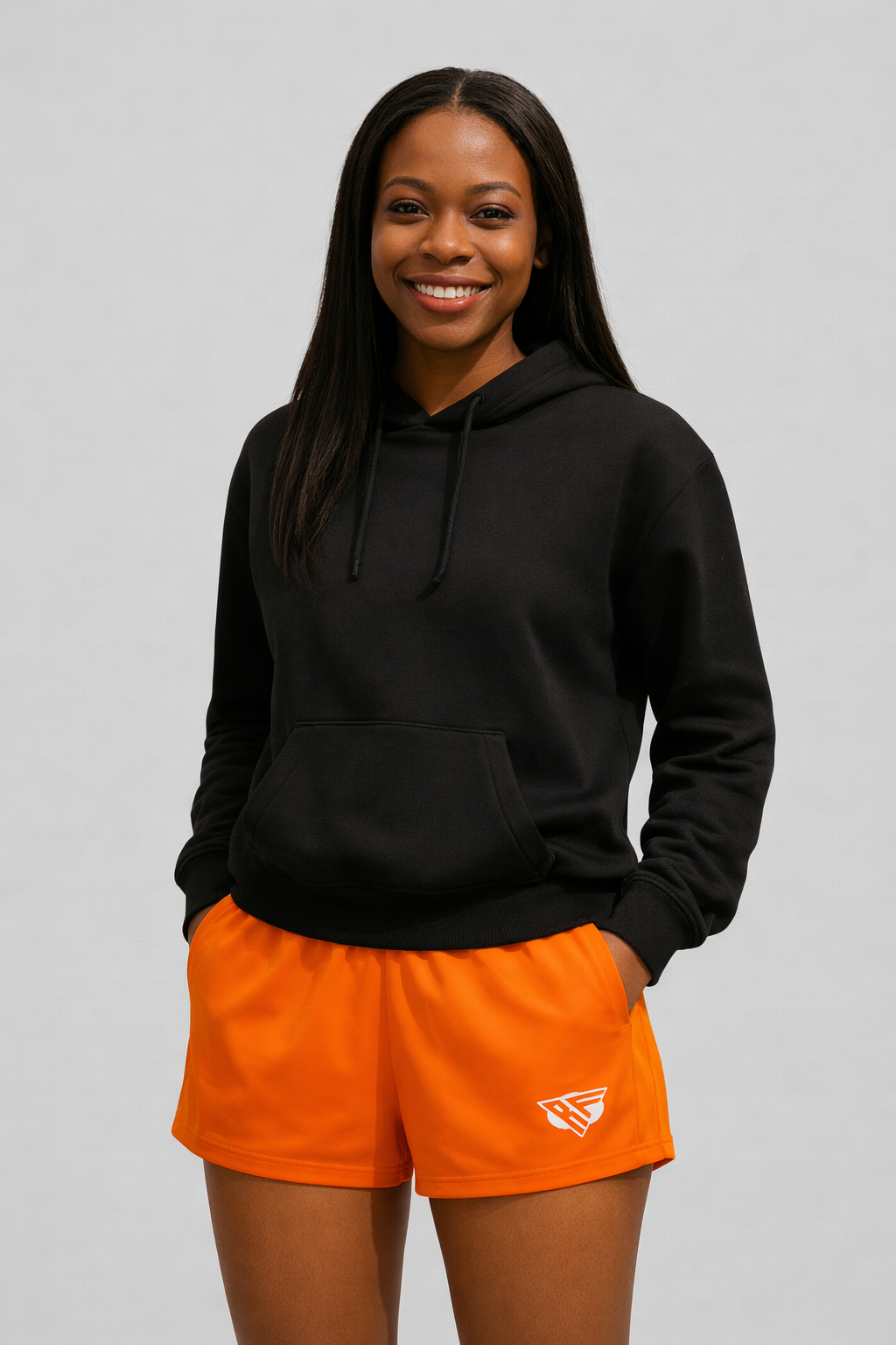 woman wearing a black hoodie and RF-Wear Women's Solid Color Shorts in Orange