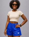 Woman wearing a white top and RF-Wear Women's Solid Color Shorts in Royal-Blue