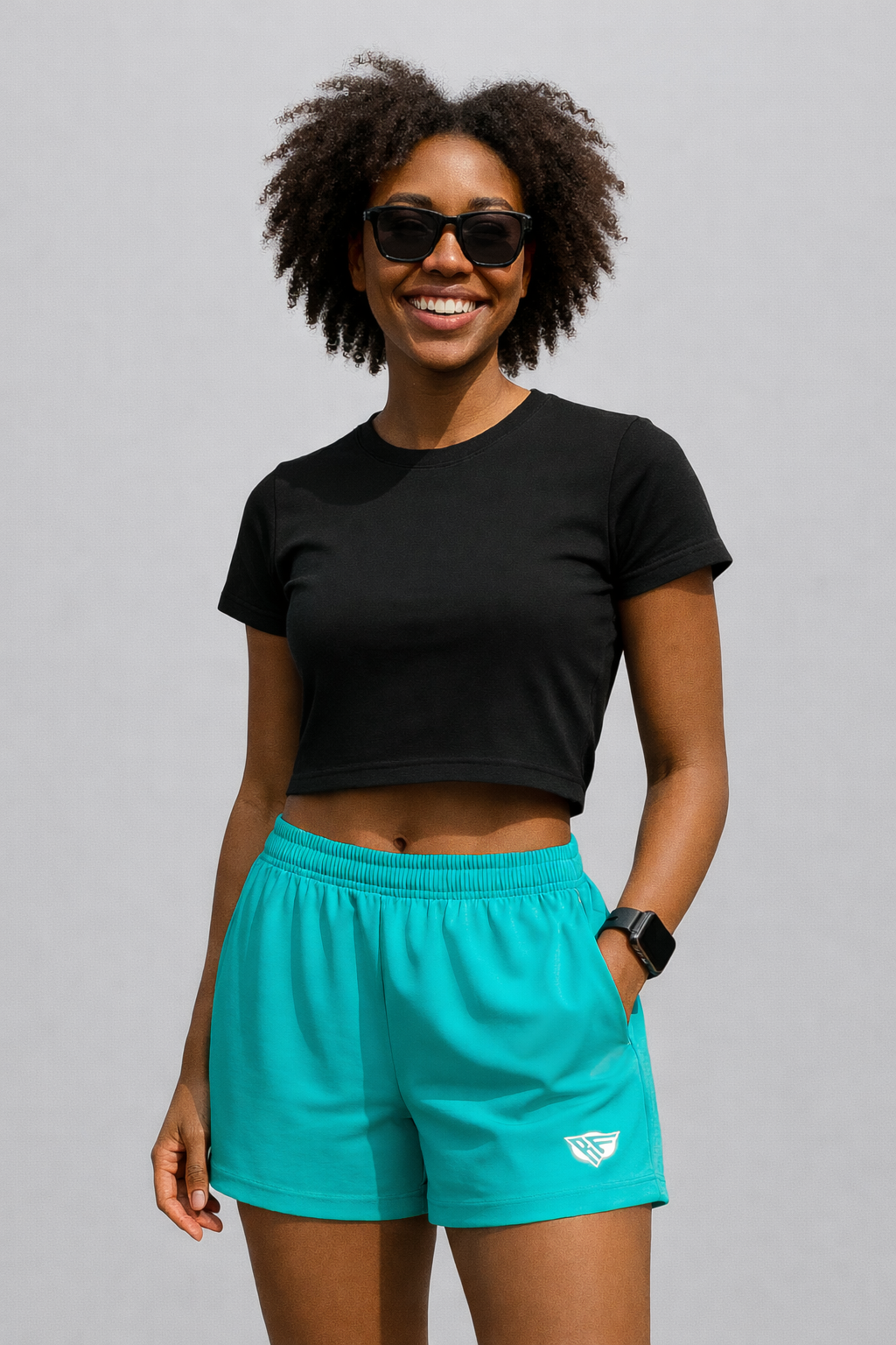 Woman wearing a black top and RF-Wear Women's Solid Color Shorts in Teal
