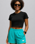 Woman wearing a black top and RF-Wear Women's Solid Color Shorts in Teal