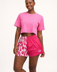 Woman wearing RF-Wear Women's Split Flame Shorts in White/Hot Pink