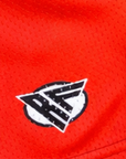 Close-up of RF-Wear Women's Split Flaming Pepper shorts in Red/Black with RF logo