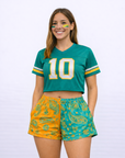 Woman wearing a jersey and RF-Wear Women's Split Paisley Shorts in Aqua/Orange