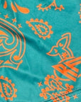 Close-up of RF-Wear Women's Split Paisley Shorts in Aqua/Orange with RF logo