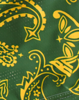 Close-up of RF-Wear Women's Split Paisley Shorts in Gold/Green with RF logo