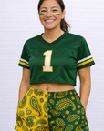 Woman wearing a green cropped jersey and RF-Wear Women's Split Paisley Shorts in Gold/Green