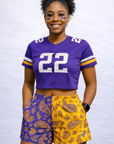 Woman wearing a purple cropped jersey and RF-Wear Women's Split Paisley Shorts in Purple/Gold