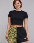 Woman wearing a black crop top and RF-Wear Women's Split Sunflower Shorts in Black/Yellow