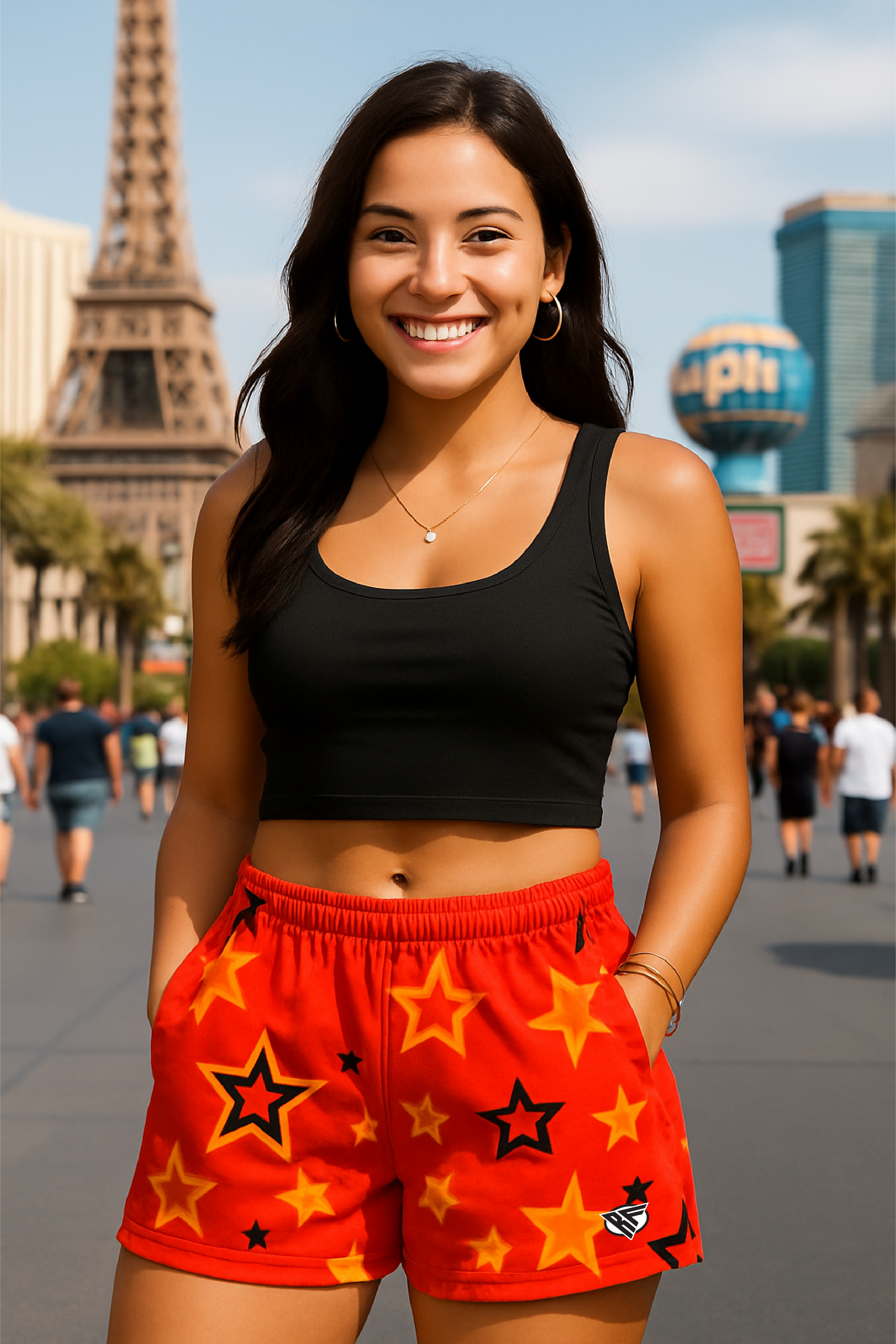 Woman wearing a black crop top and red shorts with star patterns on Vegas Strip.