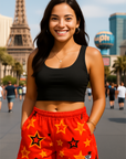 Woman wearing a black crop top and red shorts with star patterns on Vegas Strip.