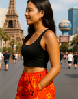Woman in black crop top and red shorts with star patterns standing on Vegas Strip. 