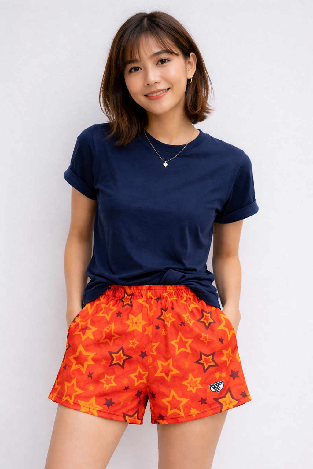 Woman wearing RF-Wear Women's Star Shorts in Orange/Yellow