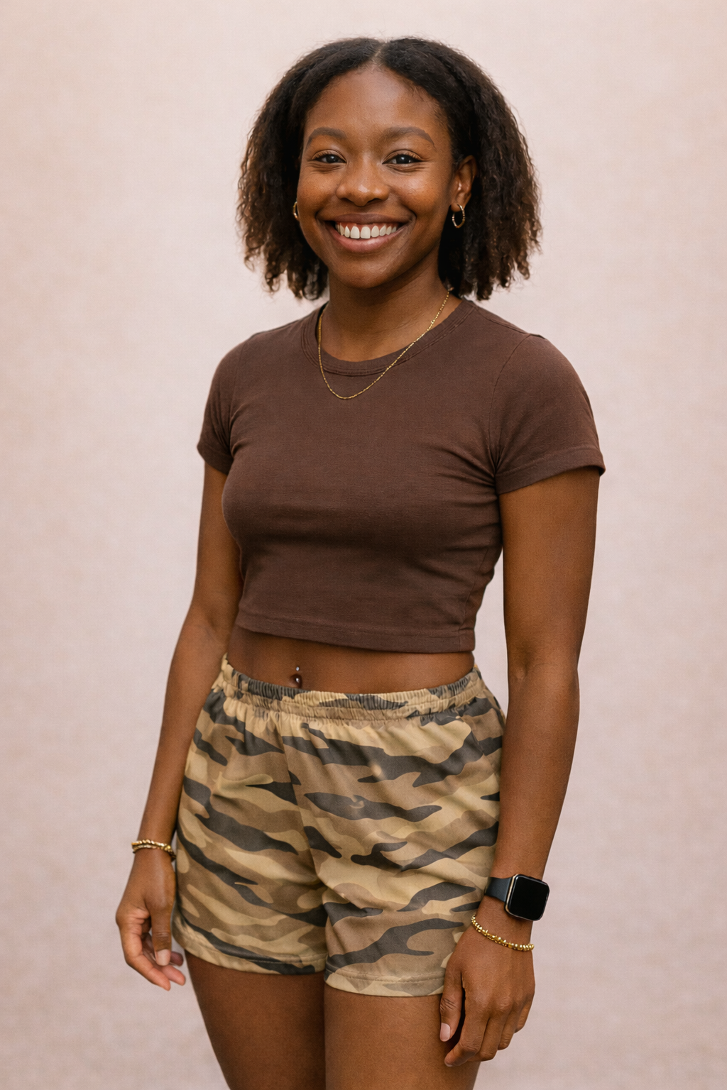 Woman wearing a brown cropped top and RF-Wear Women's Tiger Camo Shorts Tan