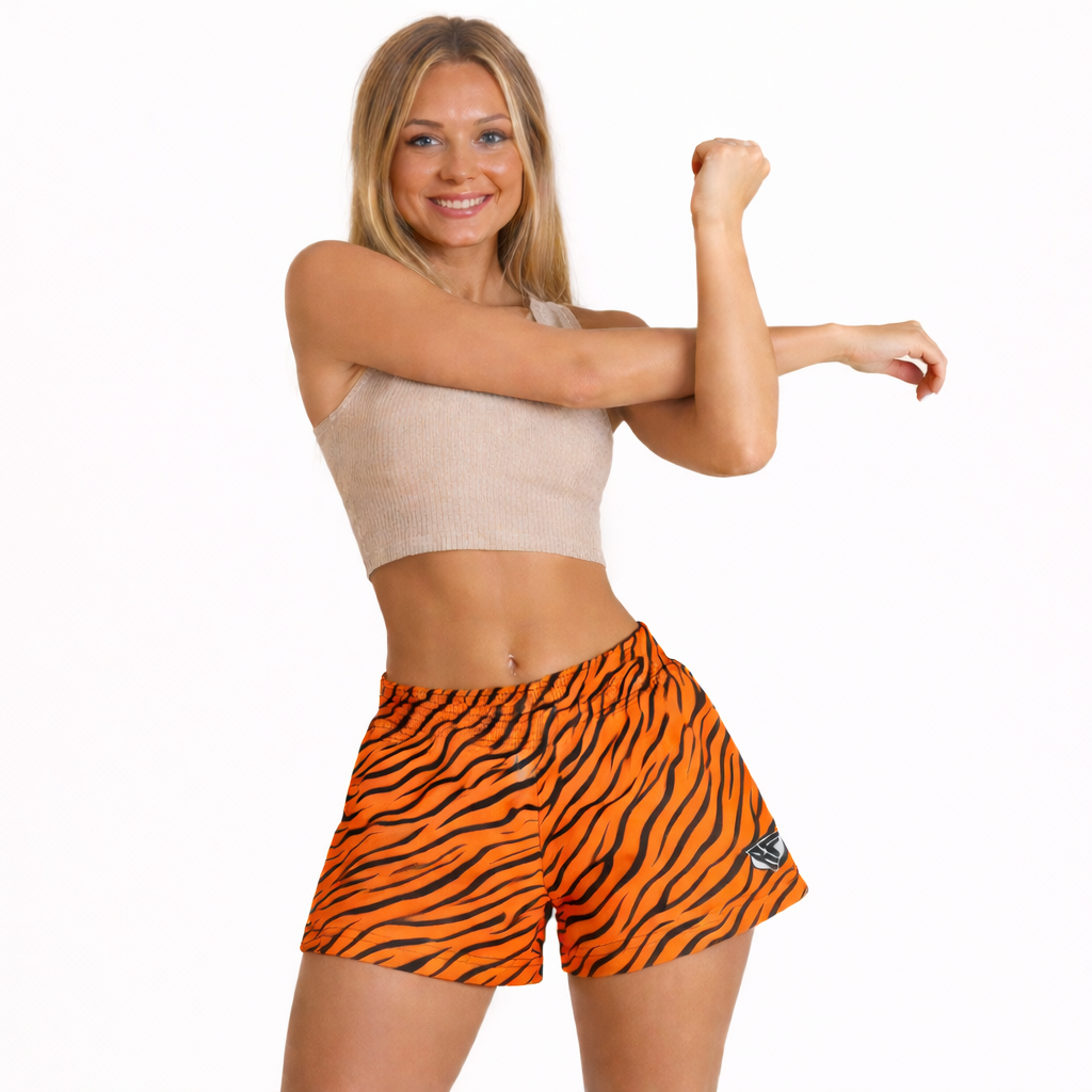 Woman wearing a beige top and RF-Wear Women's Tiger Shorts in orange/black.