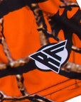 Close-up of orange tree camo shorts with a brand logo